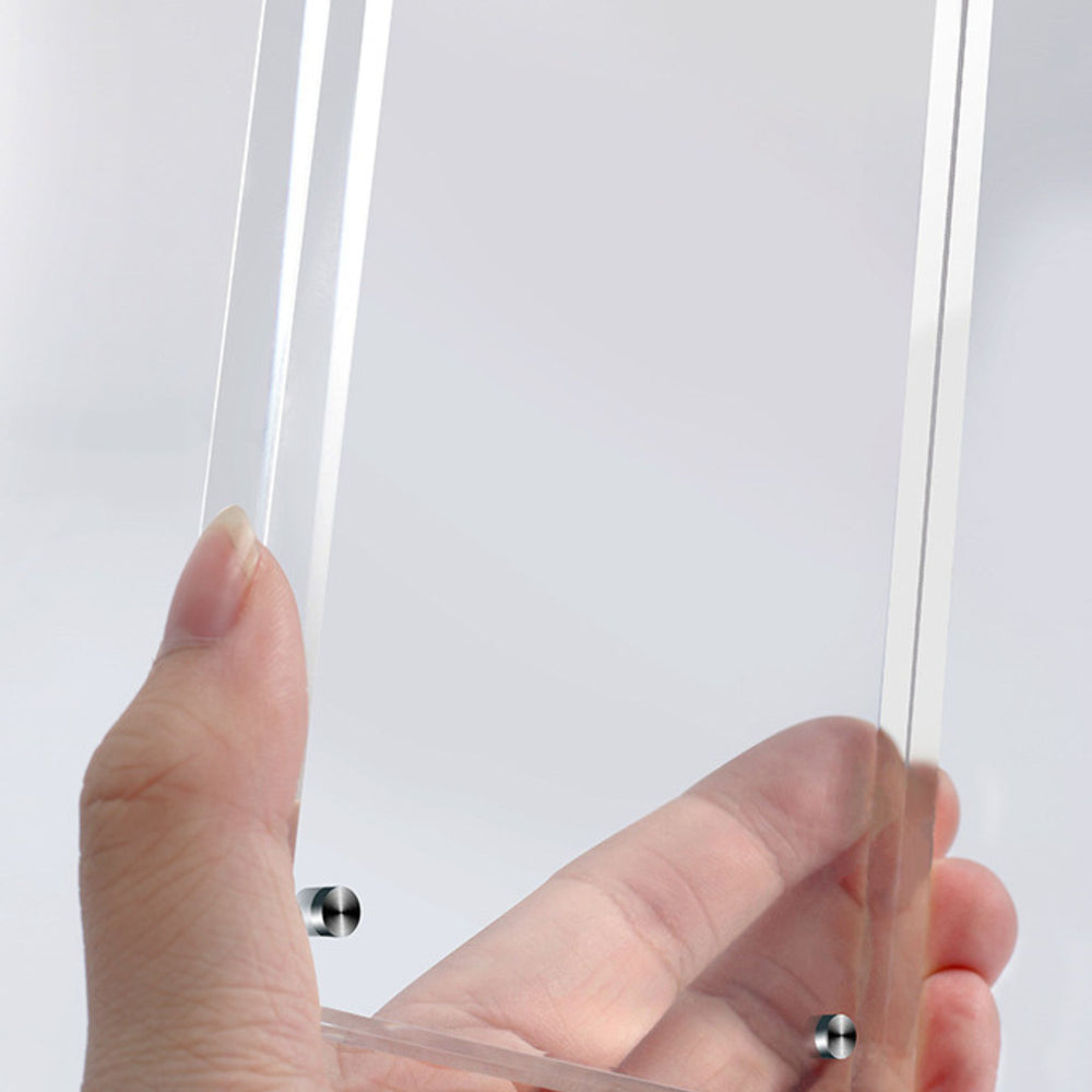 Close-up of a magnetic acrylic picture frame with a scenic design on a blurred background