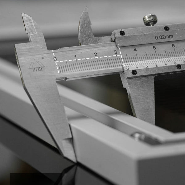 Close-up of a vernier caliper measuring the aluminum alloy back frame on the LEGO Technic acrylic display board