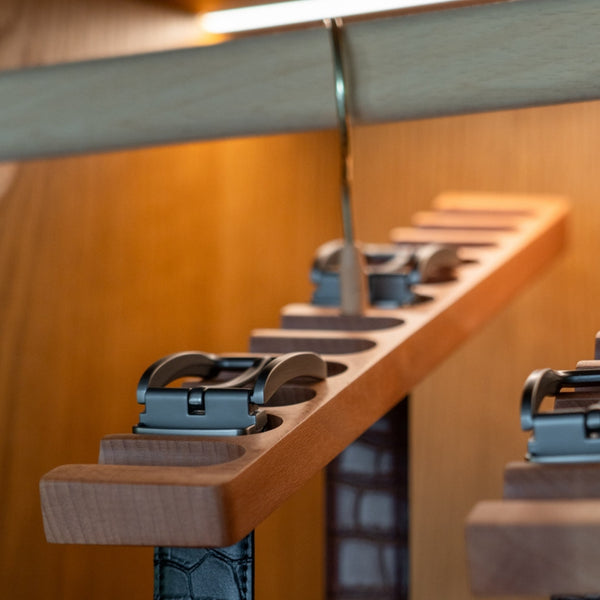 Close-up of a wooden hanger rack with jeans on a blurred background