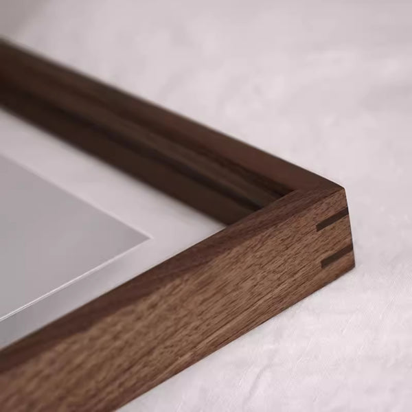 Black walnut close-up of a wooden picture frame on a white background