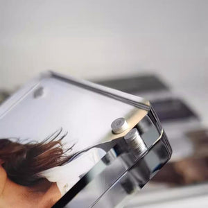 Close-up of a magnetic acrylic picture frame with a blurred image in the background