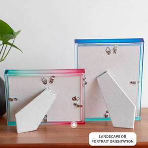 Ombre acrylic picture frames with colorful edges on a wooden surface.