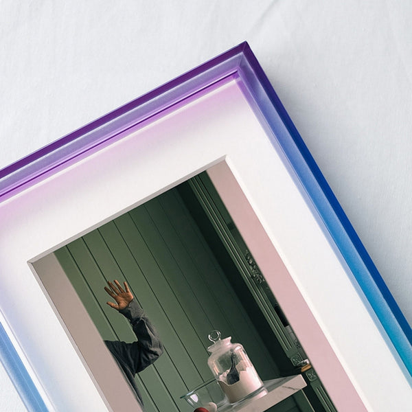 Purple and blue ombre acrylic picture frame, with a colorful frame on a white wall