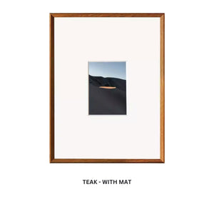 Framed artwork with a teak frame and white mat on a white background. Teak beveled picture frame with mat. 