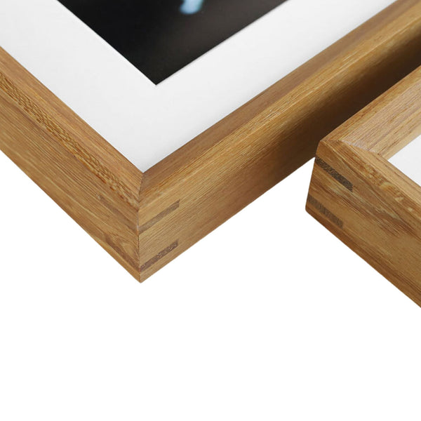 Close-up of a teak wooden frame corner on a white background