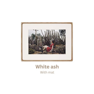 White ash wood-framed photograph of a person in a red dress sitting among cacti with 'White ash' frame text.