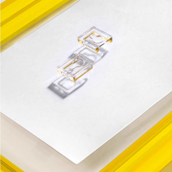 Clear yellow acrylic picture frame close up shot with wall hanger on a white background