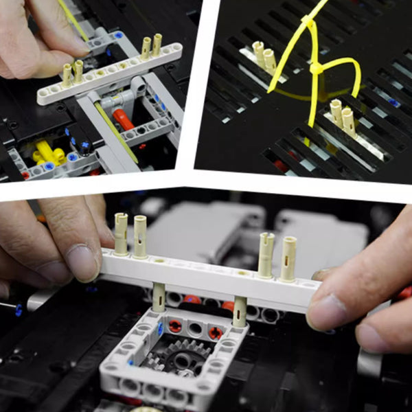 Close-up of hands assembling a mechanical model with various components.
