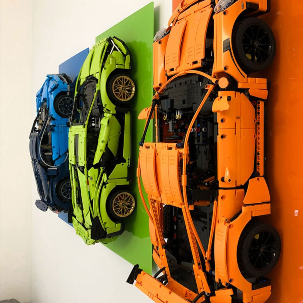 LEGO Orange Porsche 911 GT3 RS model car on an orange acrylic wall display