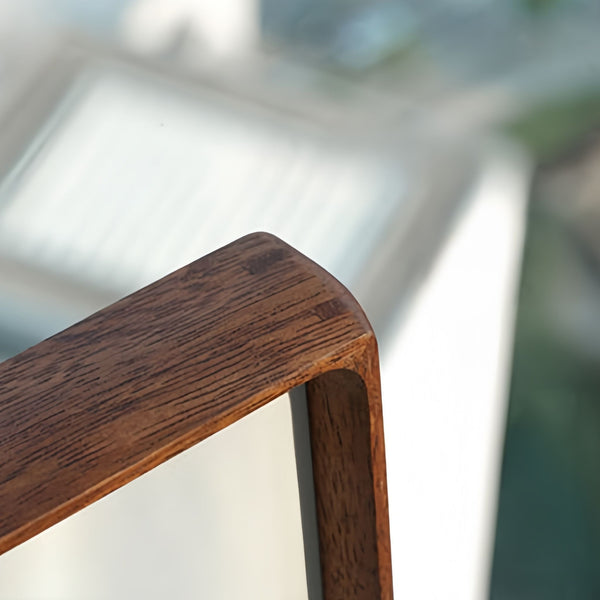 Close-up shot of merbau picture frame corner on a blurred background