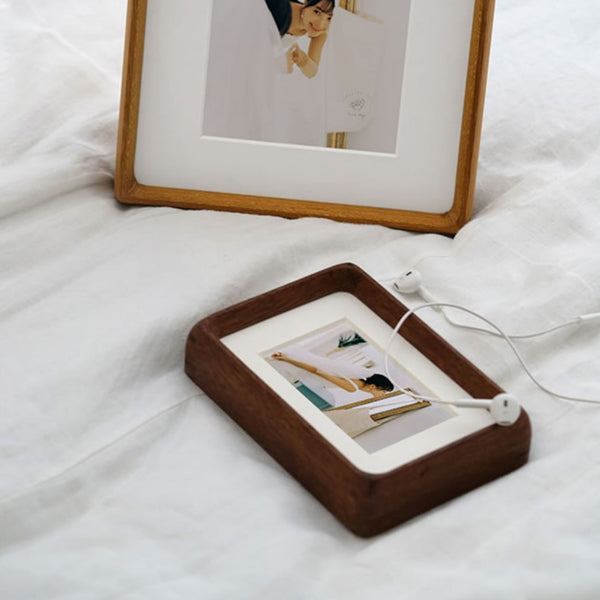 Teak and merbau wooden photo frame with a photo display on a bed