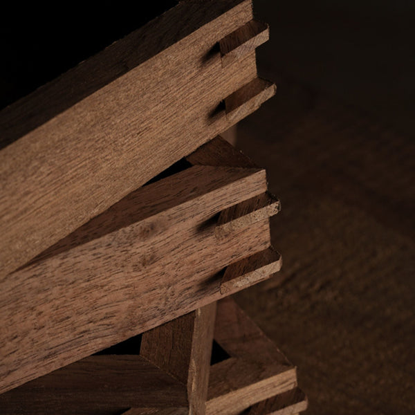 Close-up of a wooden pallet inserted into the black walnut picture frames, showing the tenon mortise joint technique